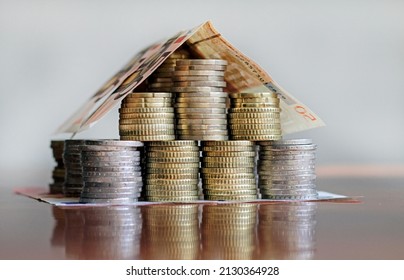 A house made out of Euro coins and bills - Mortgage, rent, investment