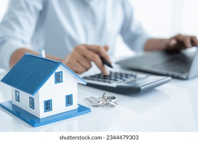 House model with agent asking costumer for contract to buy, get insurance or loan real estate or property.