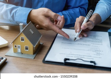 House model with agent and customer discussing for contract to buy, get insurance or loan real estate or property. - Shutterstock ID 1550239208