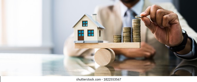 House Model Balance Equilibrium Concept. Real Estate Money - Shutterstock ID 1822553567