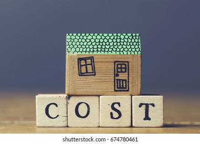 House Model With Cost Word Made From Wooden Blocks. Home Finance Concept