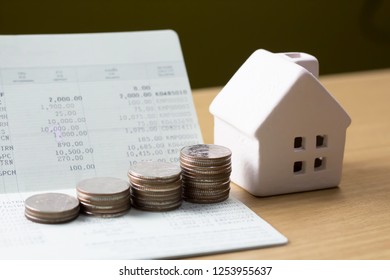 house model and Financial statement with coins, finance and loan concept, saving money, deposit account. - Shutterstock ID 1253955637