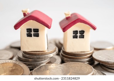 House model with growing plant on stack of coin money, home loan, saving plan, installment payment finance and banking concept. - Shutterstock ID 2311824829