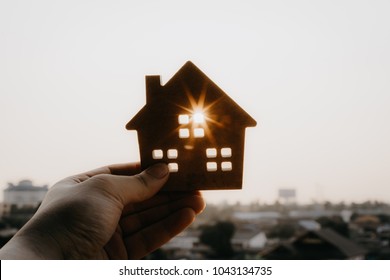 House model in home insurance broker agent ‘s hand or in salesman person. Real estate agent offer house, property insurance and security, affordable housing concepts - Shutterstock ID 1043134735