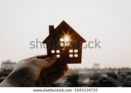 House model in home insurance broker agent ‘s hand or in salesman person. Real estate agent offer house, property insurance and security, affordable housing concepts
