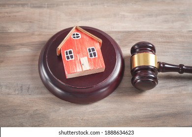 House model with a judge gavel. 