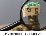 House model with magnifying glass. Property search concept