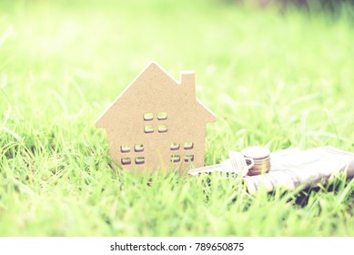 House Model, Money And Key On Green Grass Background.Home Loan For New Family.Loan For Real Estate Concept.