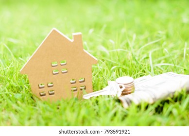 House Model, Money And Key On Green Grass Background.Home Loan For New Family.Loan For Real Estate Concept.