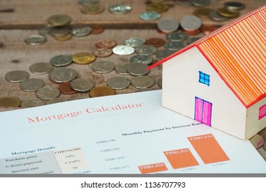 House Model And Mortage Contact Lay On Spreading Coin On Wood Table 