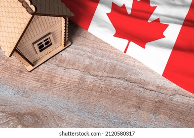 House Model Near Canada Flag. Real Estate Sale And Purchase Concept. Space For Text.