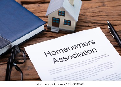 House Model Near HOA Rules And Regulations Document - Shutterstock ID 1535919590