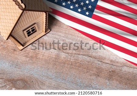 House model near USA flag. Real estate sale and purchase concept. Space for text.