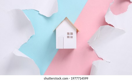 House Model On Blue-pink Background With Torn Paper. Concept Art. Pastel Color Trend. Creative Layout. Minimalism. Top View