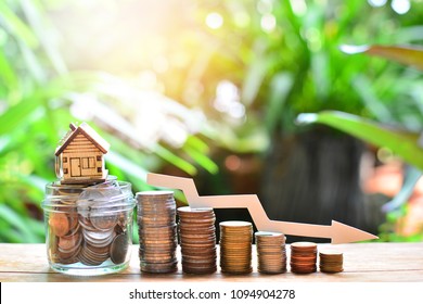 House Model On Coins Saving Set Decrease Down For Concept Interest Rate Low For Home Loan Financial And Mortgage 