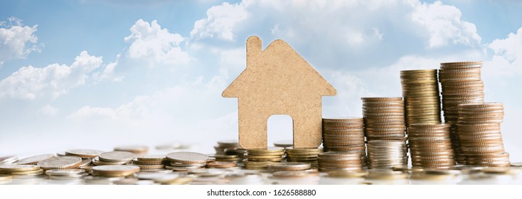 House model on coins stack for saving to buy a house. Property investment and house mortgage financial concept. Risk management concept.