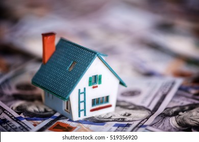 House Model On Dollar Cash Stack Closeup