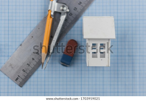 house model, ruler, drawing compass, pencils on\
paper graph