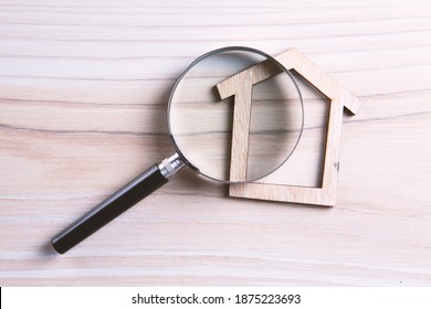 House Model Seen Through Magnifying Glass