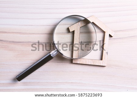 House Model Seen Through Magnifying Glass