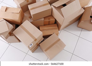 House Move Concept. Carton Boxes On Tile Floor Background