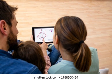 House Moving Concept - Top View Of Happy Family Choosing House Interior Design On Tablet Computer.