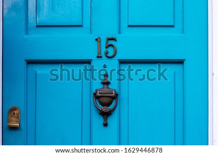 House number 15 on a blue wooden front door