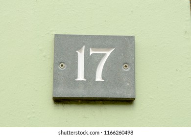 House Number 17 Sign On Green Painted Wall