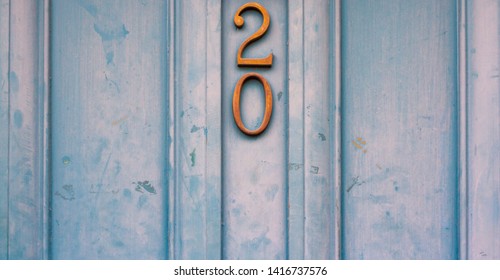 House Number 20 With The Twenty In Metal On An Old Wooden Front Door