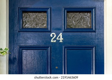 House number 24 on a blue wooden front door