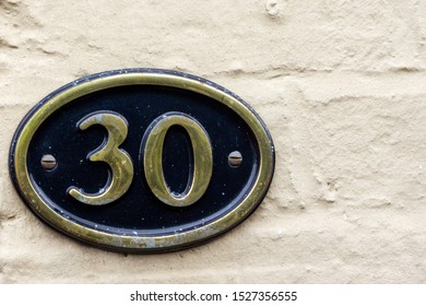 House Number 30 On An Oval Metal Sign