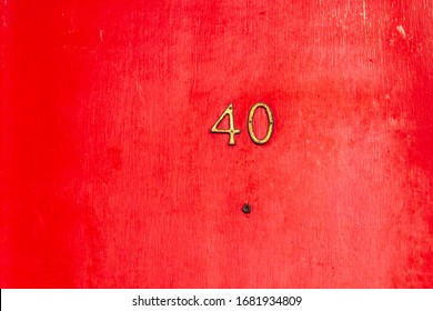 House number 40 on a red wooden front door