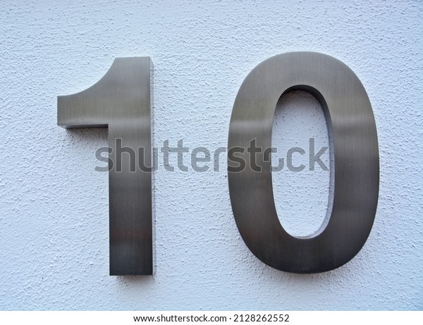 A
house number plaque, showing the number ten (number
10)