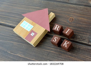 House object and wooden blocks with risk word - Shutterstock ID 1832269708
