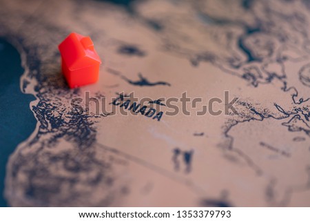 House on Canada part of world map. Selective focus. Real estate in Canada concept.
