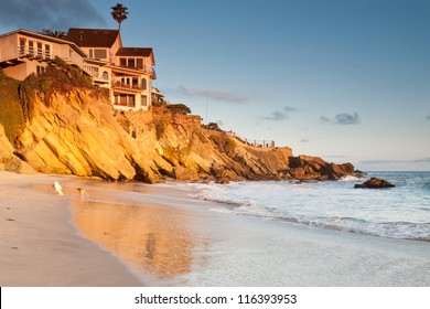 House On Cliffs With Playing Dogs Luxurious House On Cliffs In Southern California Beach With Playing Dogs On The Beach At Sunset