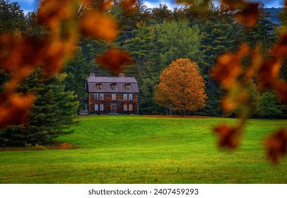 A house on the edge of the forest in autumn. Wooden cottage in autumn forest. House in autumn forest. Autumn forest house view