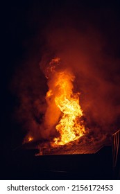House on fire at night. Topics of arson and fires, disasters and extreme events. - Shutterstock ID 2156172453