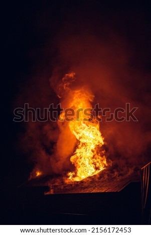 House on fire at night. Topics of arson and fires, disasters and extreme events.