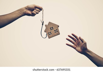 A house on a fish hook / Risks and negative sides of buying a house concept