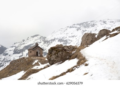 A house on the snow hills. Single house with snow covered mountains on the background. Italy April 2017 - Powered by Shutterstock