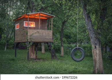 House On Tree In Evening Garden