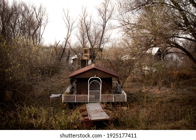 House On Wooden Raft Floats Stranded On The Shore.