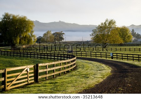 House in paddock with fog and sunrise
