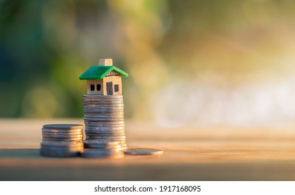 House placed on coins. planning savings money of coins to buy a home concept, concept for property ladder, mortgage and real estate investment. for saving or investment for a house.