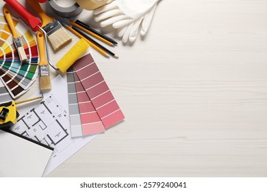 House plan and different decorator's tools on white wooden table, flat lay. Space for text