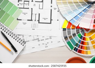 House plans and different decorator's tools on white wooden table, flat lay