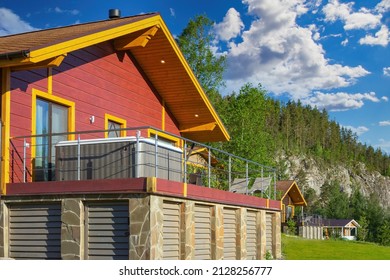 House with pool on terrace. Country cottage with hot tub. House at foot of cliff. Country eco-hotel near forest. Wooden house blue sky. Cottage with private mini pool. Modern cottage village