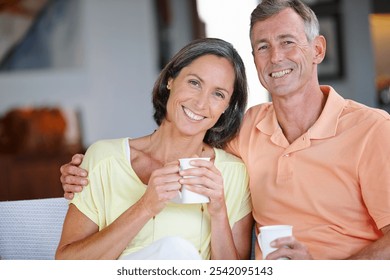 House, portrait and mature couple with coffee, smile and bonding together in living room. Apartment, senior man and woman on sofa, herbal tea or romance with morning routine, marriage or relationship - Powered by Shutterstock