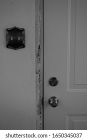 House In Progress...broken Door Frame, Old Light Switch And Door Knob With Deadbolt. In Black And White.